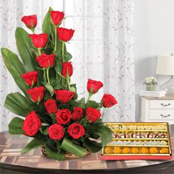 Exotic Gift of 1/2 Kg. Assorted Sweets and 18 Red Roses Bouquet Exotic Gift of 1/2 Kg. Assorted Sweets and 18 Red Roses Bouquet