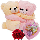 Cute Hugging Couple Teddy with 1 Velvet Rose and 3 pcs Heart Homemade Chocolate Cute Hugging Couple Teddy with 1 Velvet Rose and 3 pcs Heart Homemade Chocolate
